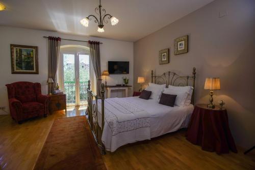 a bedroom with a bed and a chair and a window at Boutique Guest Accommodation Zephyrus in Split