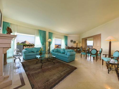 
a living room filled with furniture and a large window at Movenpick Taba Resort & Spa in Taba
