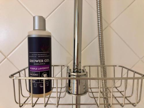 a bottle of shower gel sitting in a metal rack at Sea View Studio Apartments by the Beach in Ihasalu