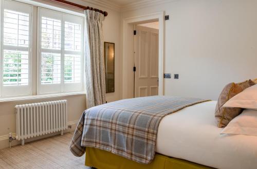 a bedroom with a bed and a window at Links House at Royal Dornoch in Dornoch