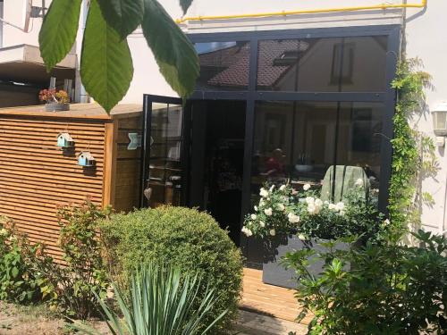 a garden room with a sliding glass door at Hotel Les Embruns in Le Touquet-Paris-Plage