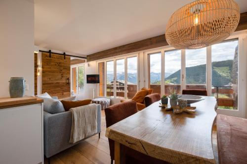 a living room with a couch and a table at Ski-in Luxury Apartement in Center La Tzoumaz in La Tzoumaz