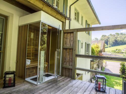 an open glass door on a balcony of a house at Hotel Krone Sihlbrugg in Sihlbrugg Dorf