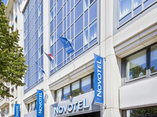 a building with blue signs on the side of it at Novotel Marseille Centre Prado Vélodrome in Marseille