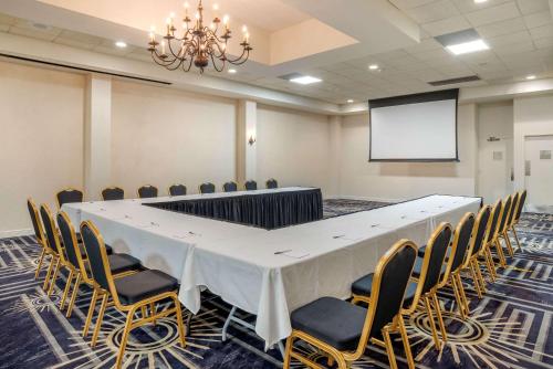 a conference room with a large table and chairs at Clarion Inn Conference Center in Gonzales