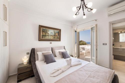 A bed or beds in a room at Panos Villa Sunset View
