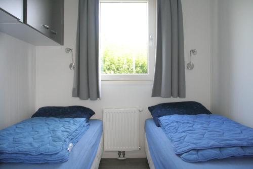 En eller flere senge i et værelse på Cassandria Bad - luxe Glamping