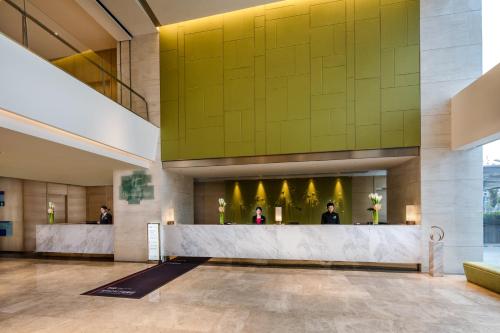 a lobby of a hotel with a reception desk at Holiday Inn Nanjing Harbour by IHG in Nanjing