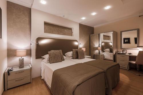 a large bedroom with a large bed and a sink at Osborne Hotel in Valletta