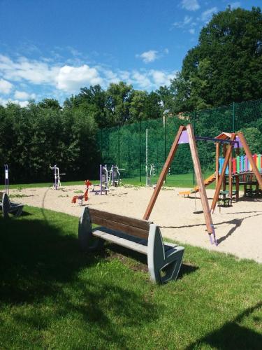 a playground with a bunch of playground equipment in a park at Gościniec Solan in Jeleniów