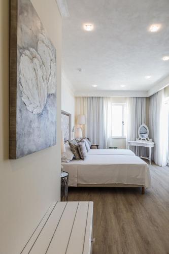 a bedroom with a bed and a painting on the wall at Osborne Hotel in Valletta