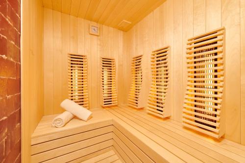 a sauna with wooden shuttered windows and a bench at Garden Suites Park Plava Laguna in Poreč