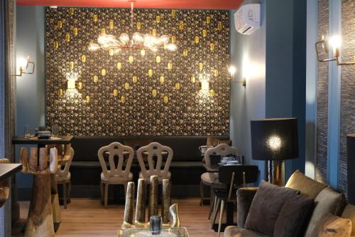 un bar con sillas y una pared con una lámpara de araña en 34 GuestHouse, en Setúbal