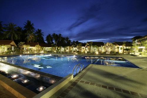 a large swimming pool at night with lights at Kuiburi Hotel & Resort in Kui Buri