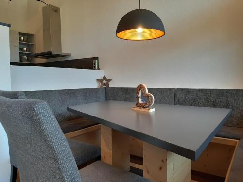 a dining room table with a heart sculpture on it at Chalet Wirklich Wunderbar in Leutasch