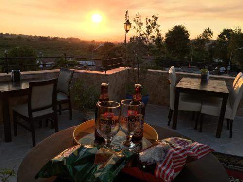 a table with two wine glasses on a patio at Rebetika Hotel & bistro in Selcuk