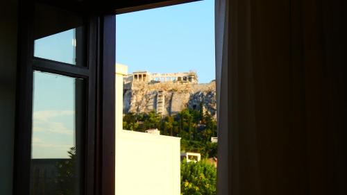 a window with a view of a mountain at Theasis Athens in Athens