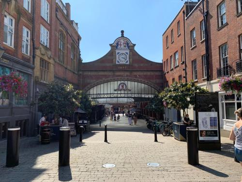 a building with a clock tower in the middle of a street at Goswell House Hotel central Windsor in Windsor