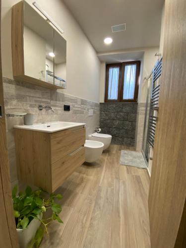 a bathroom with a sink and a toilet and a mirror at Rusina in Santa Venerina