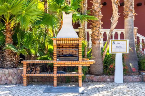 a fireplace in front of a resort with a sign at Fazenda Viegas in Lagos
