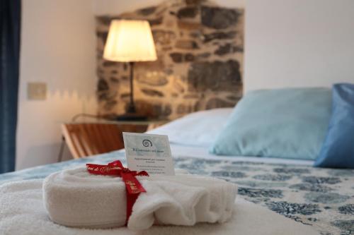 a towel sitting on top of a bed at Il Convento sul Mare in Santo Stefano al Mare