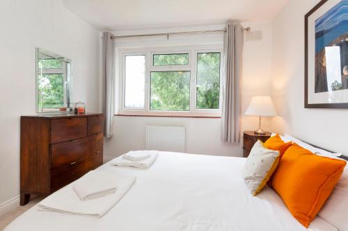 a bedroom with a white bed and two windows at Woodlea House with Hot tub in York