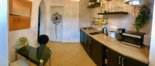 a large kitchen with a counter and a counter top at Apartment Anglicka 138 in Mariánské Lázně