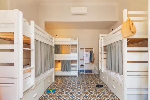 a room with four bunk beds and a hallway at Costello in La Spezia