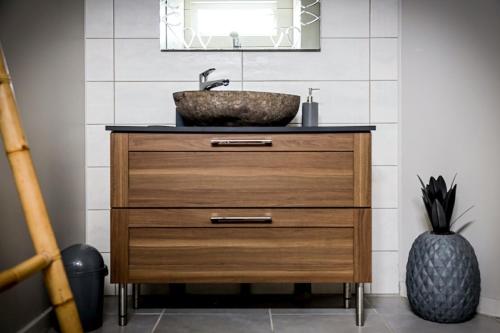 a bathroom vanity with a sink and a mirror at Archipel Maimeo in Saint-François