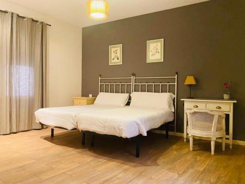a bedroom with a bed and a table with a lamp at Alda Apartamentos Muralla de Toledo in Toledo