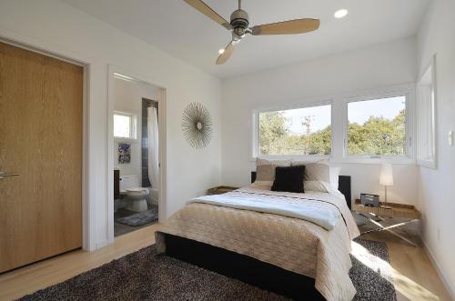 a bedroom with a bed and a ceiling fan at Park Lane Modern in Austin