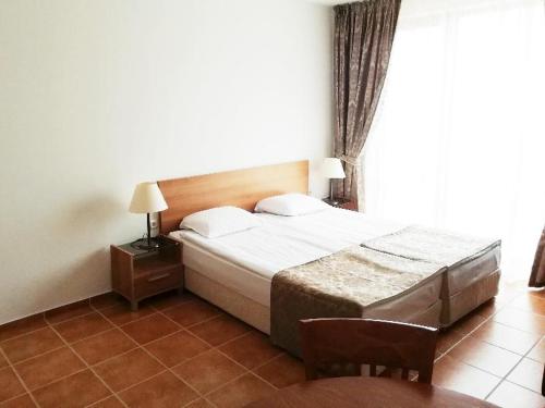 a hotel room with a bed and a window at Apart Hotel Efir in Sunny Beach