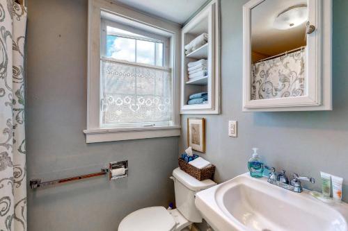 baño con aseo y lavabo y ventana en Maine Memories, en Wiscasset