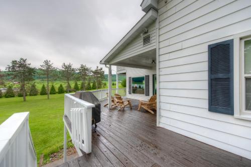a porch of a white house with a wooden deck at Amazing Grace in McHenry
