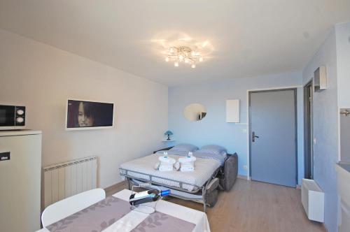 um quarto de hospital com uma cama e uma mesa em Studio Plage du Grazel em Gruissan