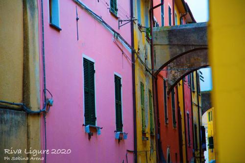 a group of buildings in a narrow street at Il Convento sul Mare in Santo Stefano al Mare