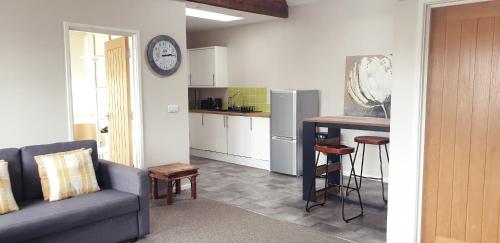 a living room with a couch and a kitchen at Southcourt in Worthing