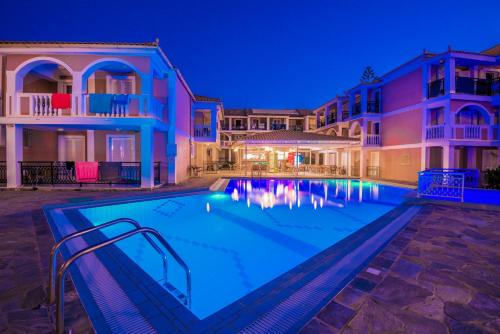 a swimming pool in a villa at night at Boletsos Beach in Argasi