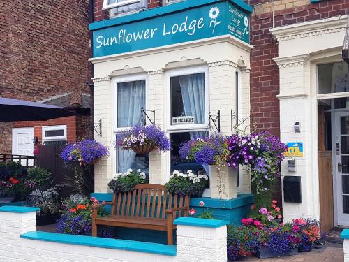 a bench in front of a flower shop at Sunflower Lodge in Bridlington
