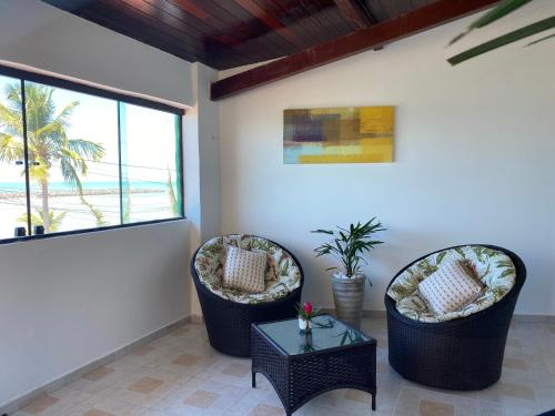 a living room with two chairs and a table at Taverna do Paraiso in Janga