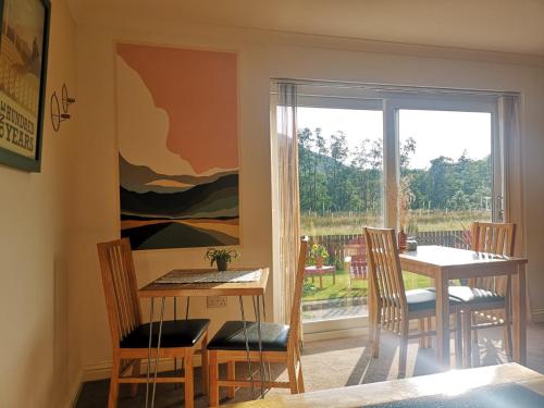 a dining room with a table and chairs and a window at Forest View Guesthouse, Kinlochleven WHW in Kinlochmore