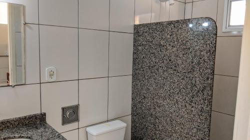 a bathroom with a toilet and a shower in it at Residência Schneider RC in Vila Velha