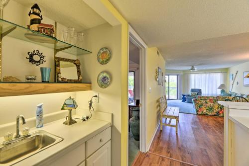 a kitchen with a sink and a living room at Point Emerald Resort Retreat Walk to Beach! in Emerald Isle