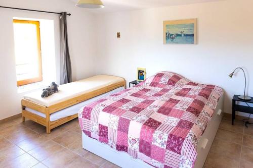 a bedroom with a bed and a window at Rouretord Hirondelle in Gilhac-et-Bruzac