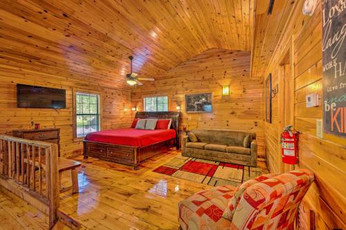 a room with a bed and a couch in a cabin at Ideally Located Broken Bow Cabin - Private Hot Tub in Broken Bow