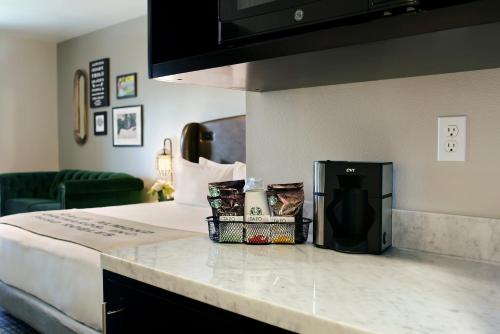 a hotel room with a bed and a counter top at Oxford Suites Paso Robles in Paso Robles