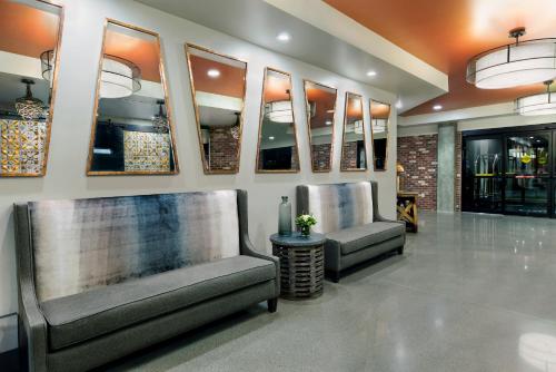 a lobby with two chairs in a store at Oxford Suites Paso Robles in Paso Robles