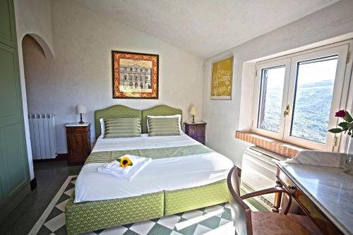 a bedroom with a green bed with a dog on it at Borgo Riccio in Torchiara