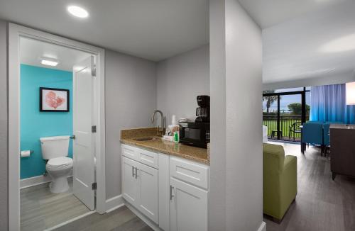 a bathroom with a sink and a toilet in a room at Grande Cayman Resort in Myrtle Beach