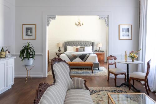 a living room with a bed and a couch at The Holbrooke Hotel in Grass Valley